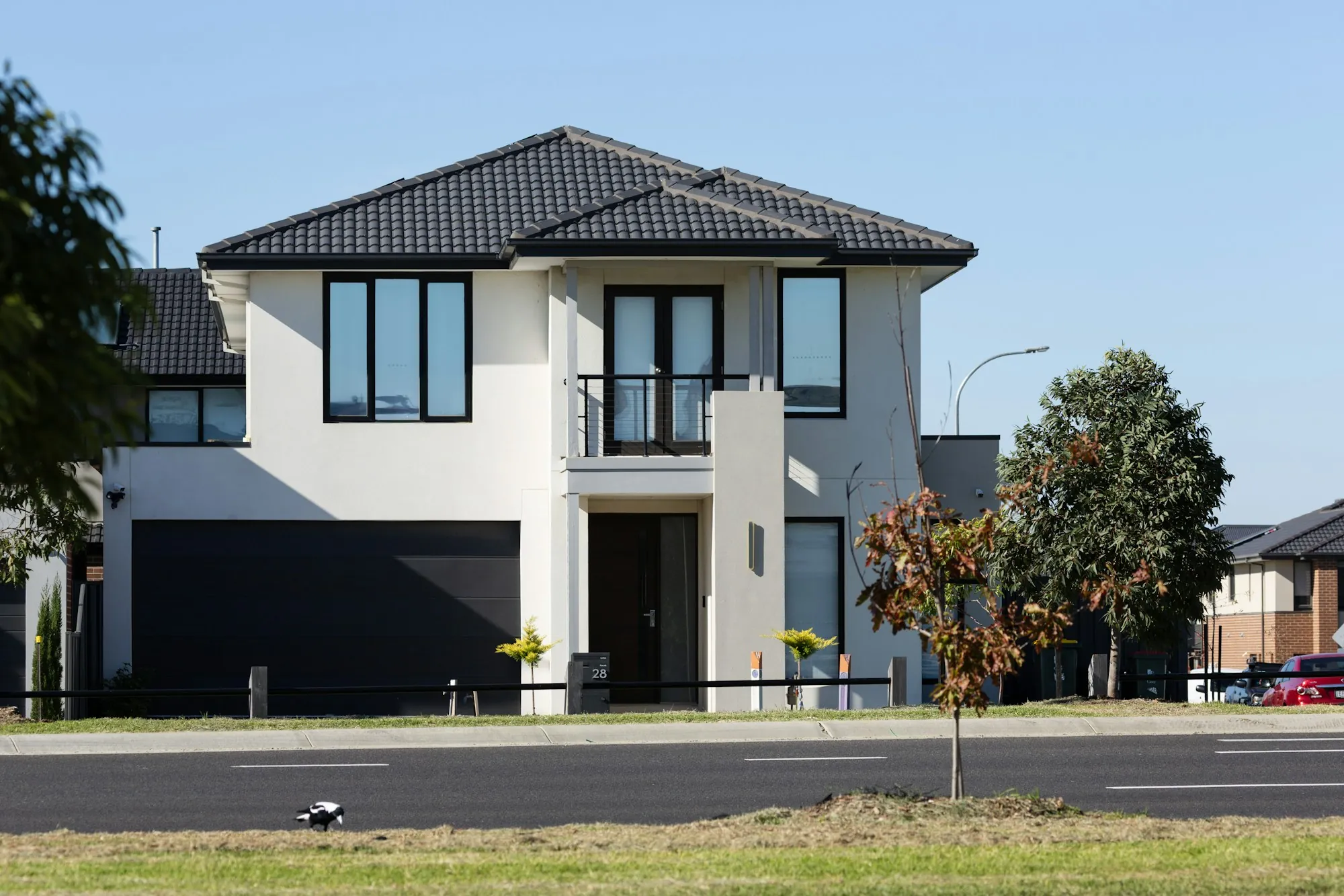 Modern two-story home with a dark garage door