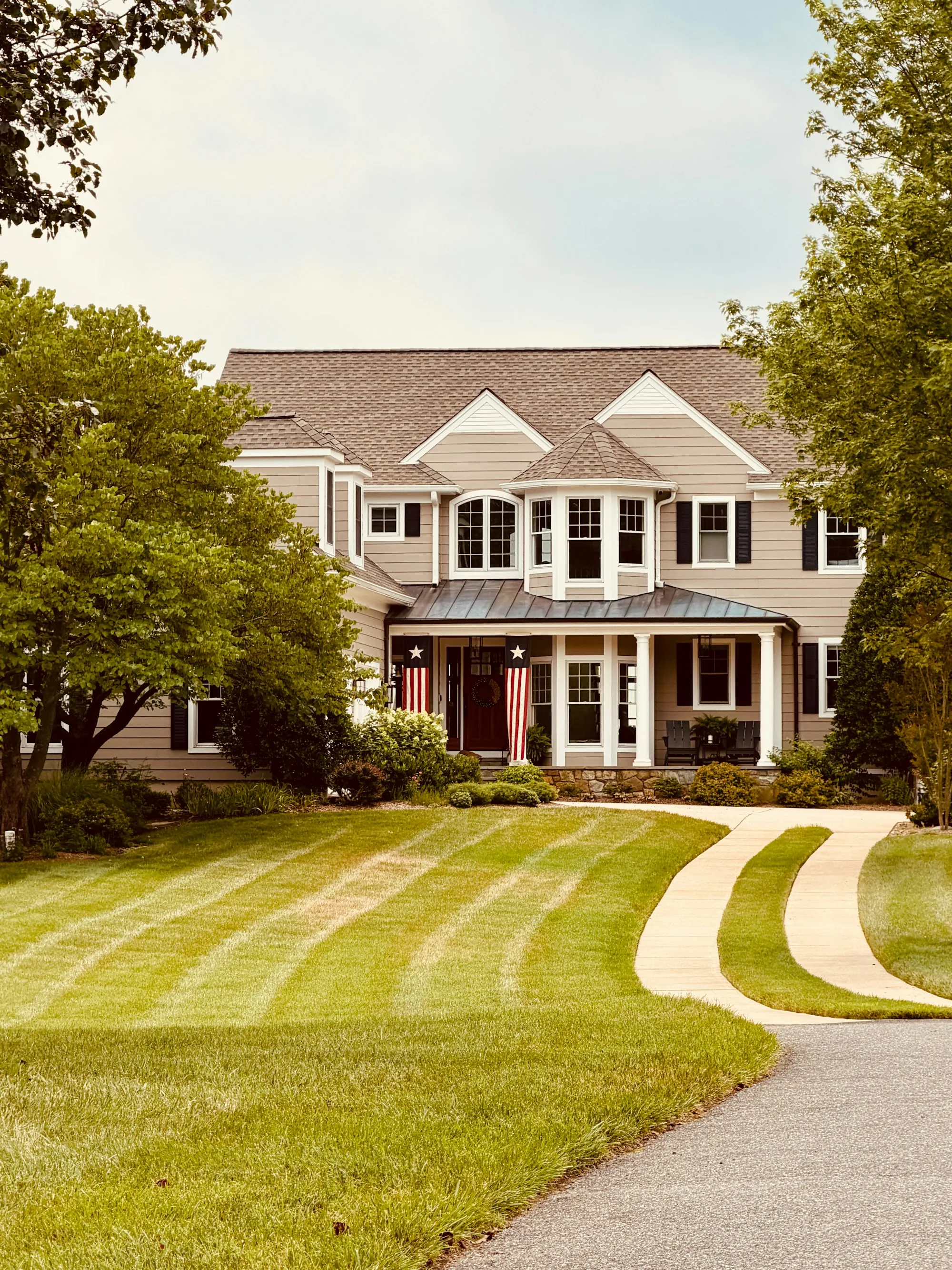 Large suburban home with walkways across the front lawn