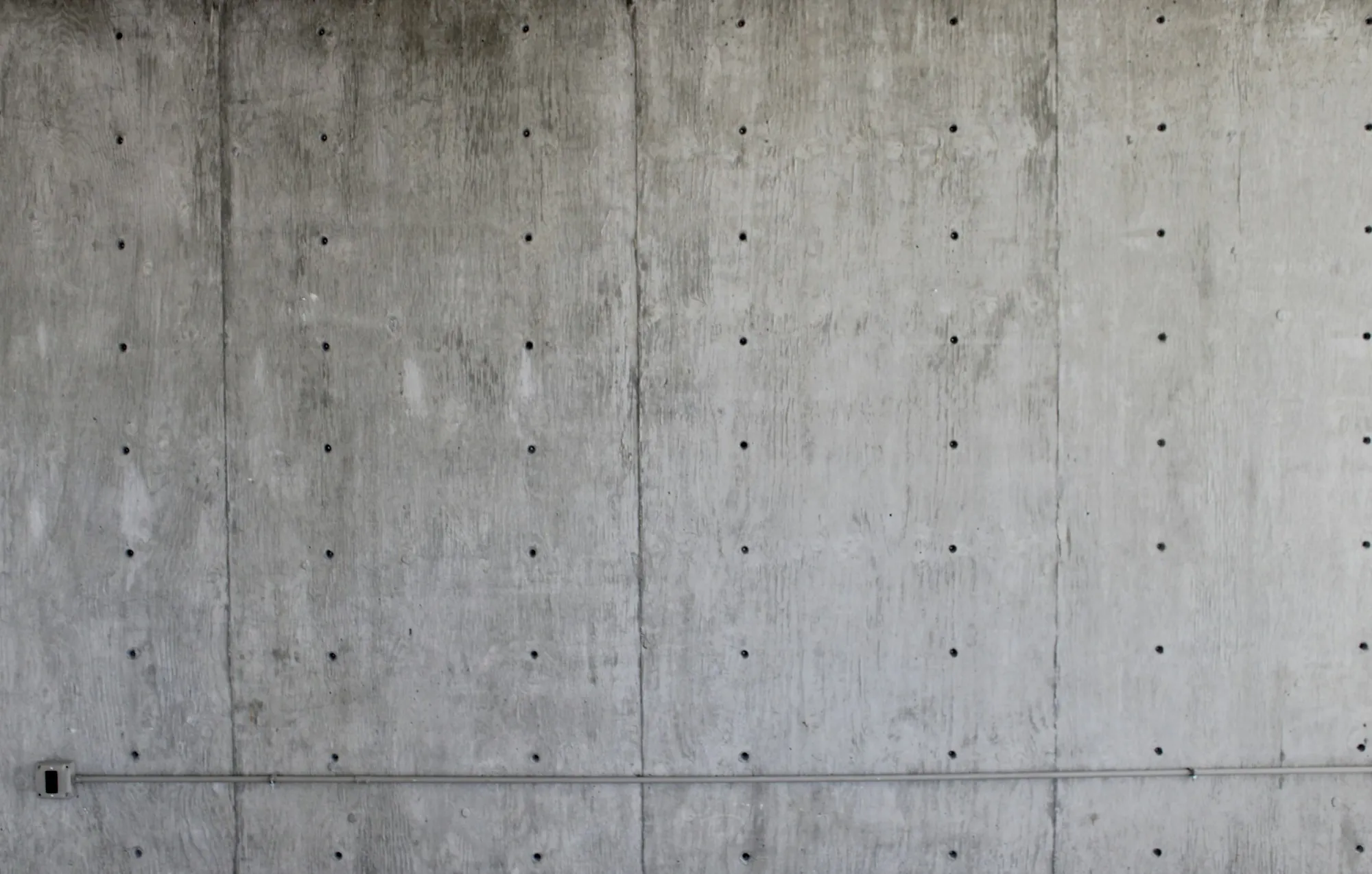 Formed concrete wall with rows of tie holes